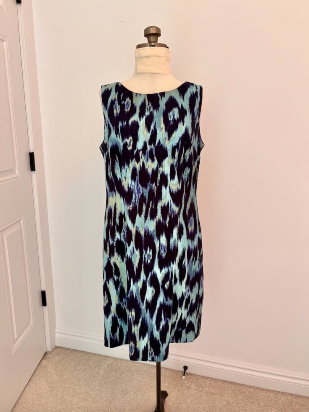 Connected Apparel dress features sleeveless design and an abstract animal print